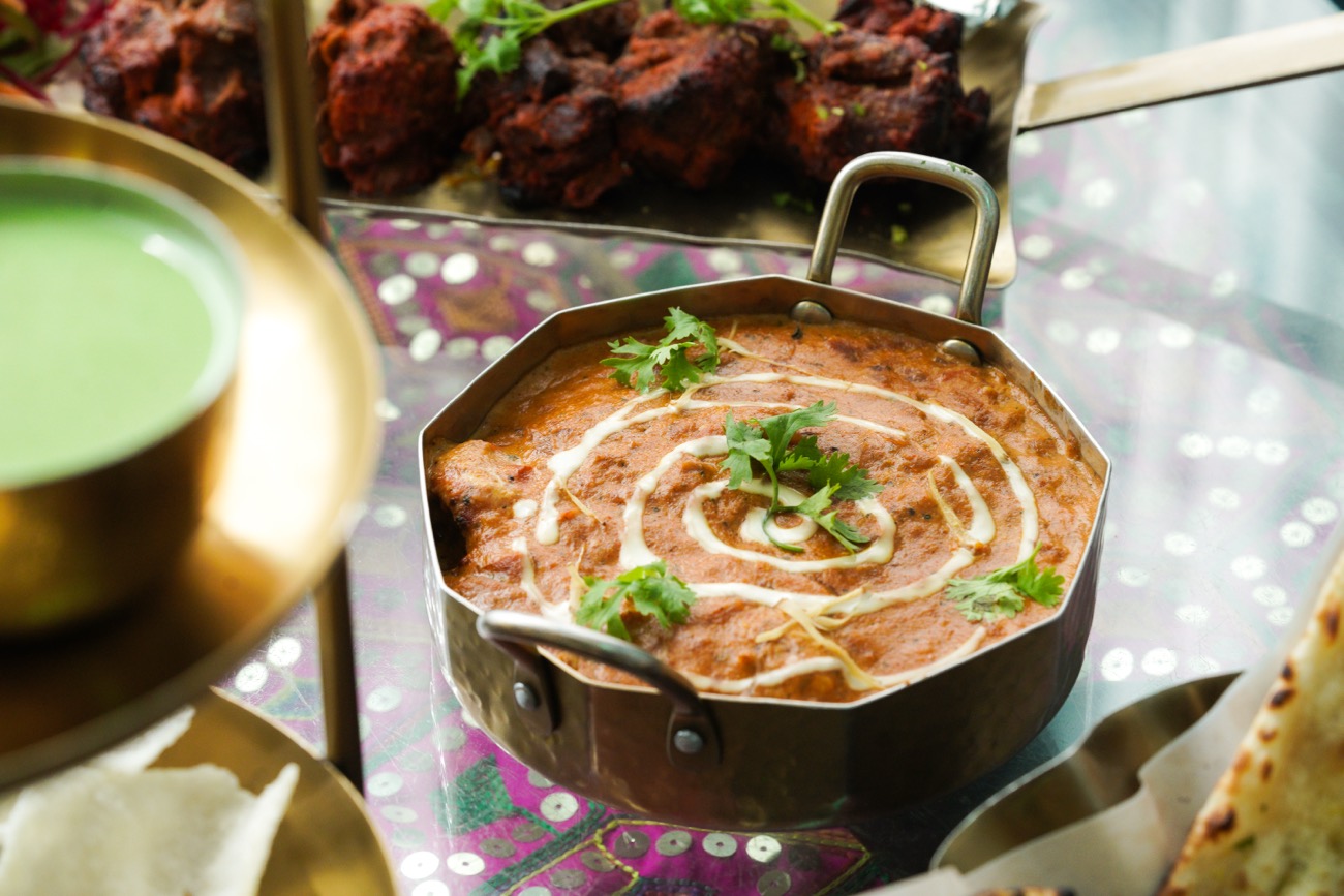 Dal makhani and tandoori starters on a brass thali, a sample post