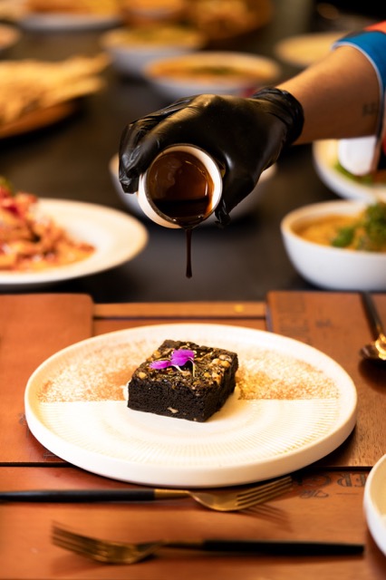 A brownie with a chocolate pour
