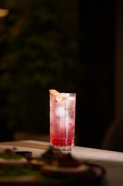 A pink cocktail on a bar